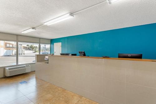 an office with a blue wall and a reception counter at Rodeway Inn in Orange Park
