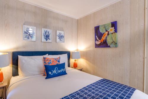 a bedroom with a bed with blue and white sheets at Kahana Reef in Kahana