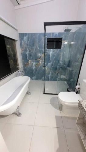 a bathroom with a shower and a sink and a toilet at La Soñada casa quinta Premium in Piribebuy