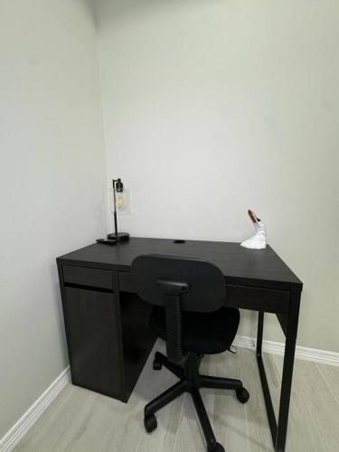 a black desk with a chair in a room at Welcome to Launchpad Living! in Brownsville