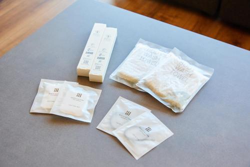 a table topped with white napkins and a remote control at Hub-Fun in Katsuno