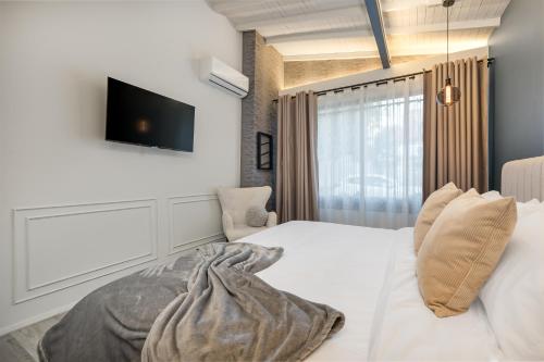 Ένα ή περισσότερα κρεβάτια σε δωμάτιο στο Nago Hometel Boutique