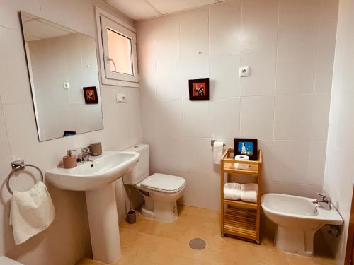a bathroom with a sink and a toilet and a mirror at Pool, Beach and Sun in Mar Menor Golf Resort in Torre-Pacheco