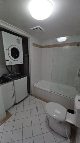 a bathroom with a toilet and a shower and a sink at Blue Waters Apartments in Gold Coast
