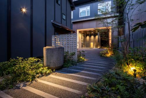 a walkway leading to a building at night at Tokyu Stay Kyoto Sanjo-Karasuma in Kyoto