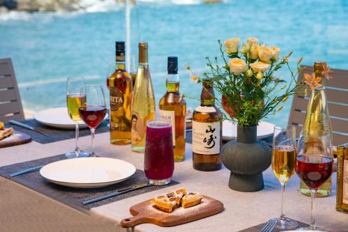 a table with wine bottles and glasses of wine at 东山一个庐野奢帐篷营地 in Yanya