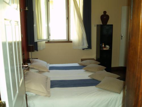 a group of four beds in a room at Palmeiras Guest House Maputo in Maputo