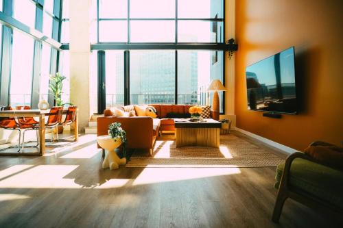 a living room with a couch and a table at NEW Pause Penthouse Lofts -Downtown- Free Parking in Halifax