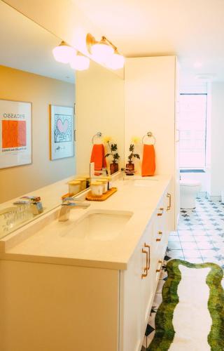 a bathroom with two sinks and a large mirror at NEW Pause Penthouse Lofts -Downtown- Free Parking in Halifax