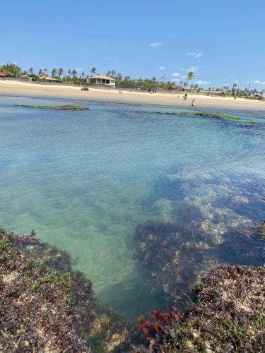 a beach with clear blue water and a sandy beach at Pousada Vibe Guajiru in Trairi
