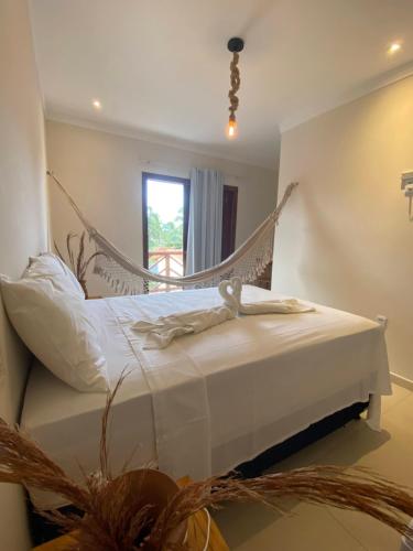 a bedroom with a swing bed in a room at Pousada Vibe Guajiru in Trairi