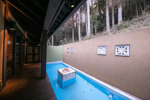 a swimming pool with a table in the middle of a building at Yufuin Hotel Mori-no-Terrace in Yufuin