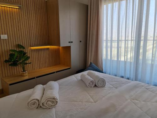 a bedroom with a bed with towels on it at Madinaty Elite Living Apartment in New cairo