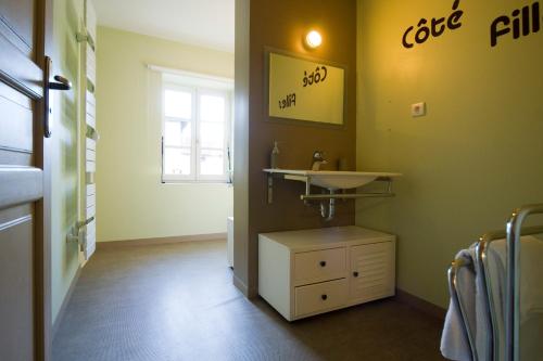 a small bathroom with a sink and a window at B&B La Cerisaie in Francheleins