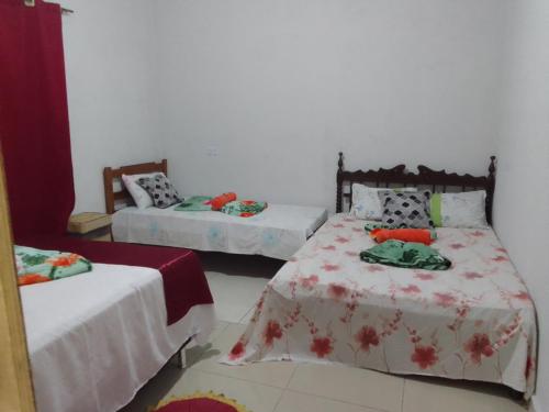 two beds in a room with two beds sidx sidx sidx at Pousada Moranga in Carolina