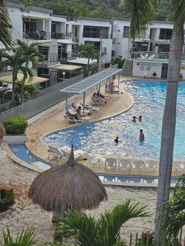 a large swimming pool with people in a resort at Apartasol Ciudadela Santa Fé "El Refugio" in Santa Fe de Antioquia