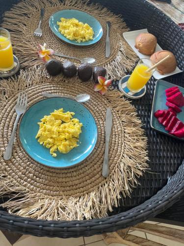 a table with two blue plates of food and drinks at Villa Bali Santai in Kerobokan