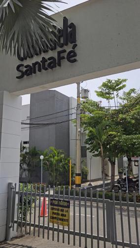 a sign in front of a sant accelerate building at Apartasol Ciudadela Santa Fé "El Refugio" in Santa Fe de Antioquia