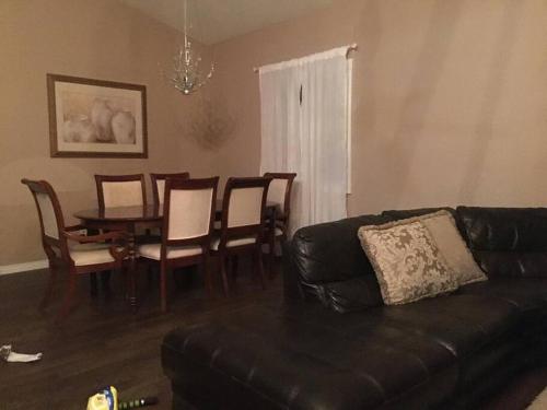 a living room with a couch and a table and chairs at Renovated 4 bedrooms 20 sleeps Shopping Center in Edmonton