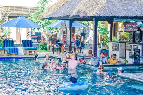 a group of people in the swimming pool at a resort at The Lokha Legian Resort & Spa in Legian