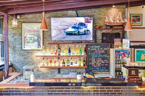 a bar with a car on the screen on the wall at The Lokha Legian Resort & Spa in Legian