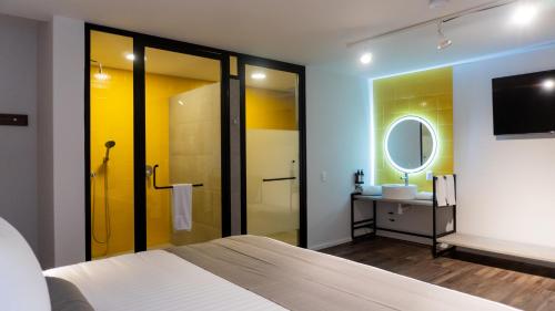 a bedroom with a bed and a sink and a mirror at ALT URBANA in León