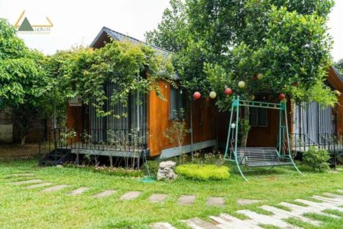 a house with an apple tree and a swing at ST Homestay Tản Lĩnh - Venuestay in Mỹ Khê