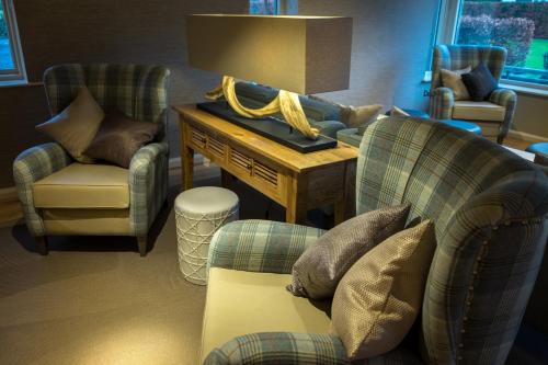 a living room with two chairs and a table and a couch at The Grand at Grasmere in Grasmere