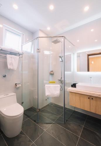 a bathroom with a shower and a toilet and a sink at HOANG LINH PHAT HOTEL in Da Lat
