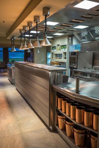a commercial kitchen with a counter with pots and pans at The Grand at Grasmere in Grasmere