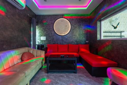 a living room with a couch and a table at 99 Pool Villa in Jomtien Beach