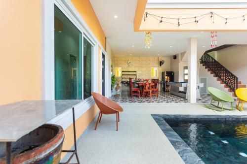 a house with a swimming pool and a living room at 99 Pool Villa in Jomtien Beach