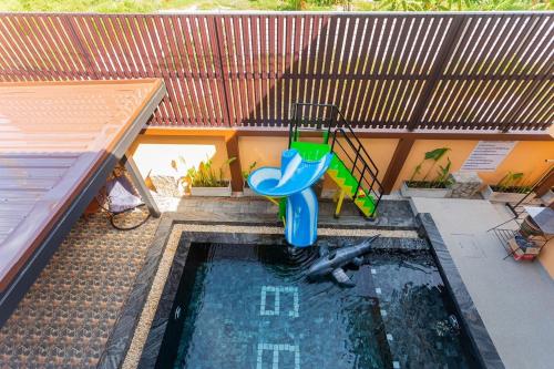 a small pool with a slide in a house at 99 Pool Villa in Jomtien Beach