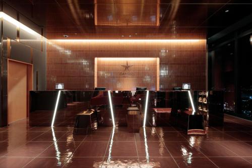 a restaurant with a table and chairs in a room at Candeo Hotels Osaka Hirakata in Hirakata