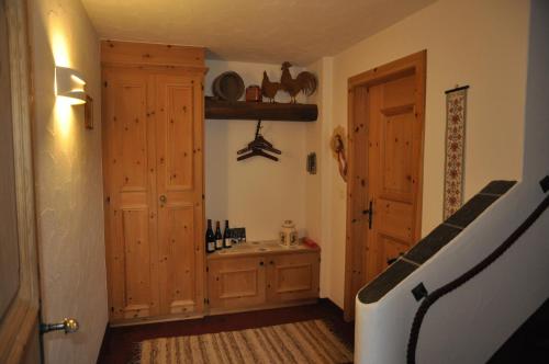 a bathroom with a sink and a wooden door at Chesa Viletta in La Punt-Chamues-ch