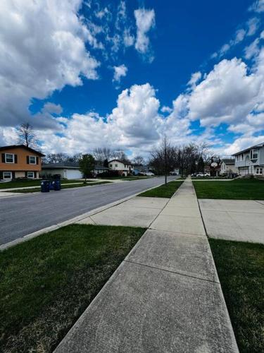 an empty street in a residential neighborhood with at Convenient Stay near Chicago Ohare Airport with King Beds and Coffee in Des Plaines