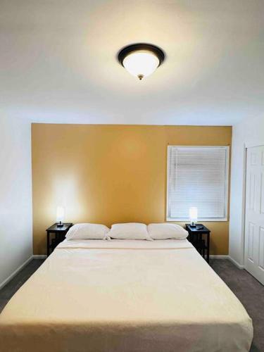 a bedroom with a large bed with two night stands at Convenient Stay near Chicago Ohare Airport with King Beds and Coffee in Des Plaines