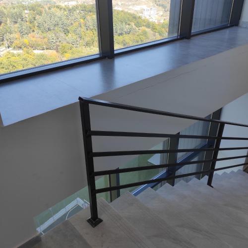 a glass staircase in a building with a window at Kechi Apart, Hotel Nice View No 139, 6th floor in Tsaghkadzor