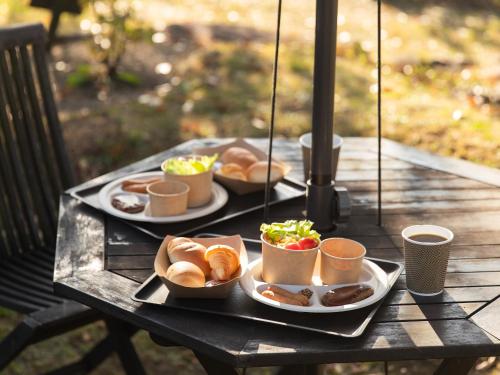 a table with two plates of food on it at くじゅう花公園 グランピングパーク花と星 in Kuju