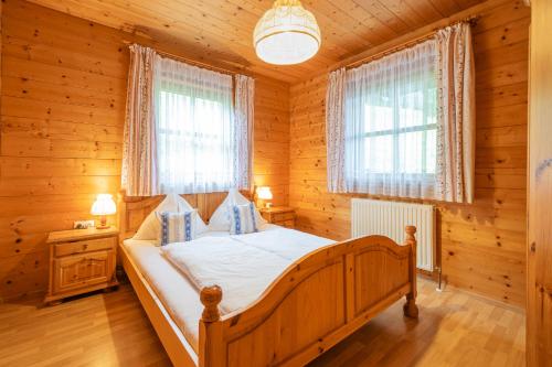 a bedroom with a bed in a log cabin at Apartment Lehengut in Eben im Pongau