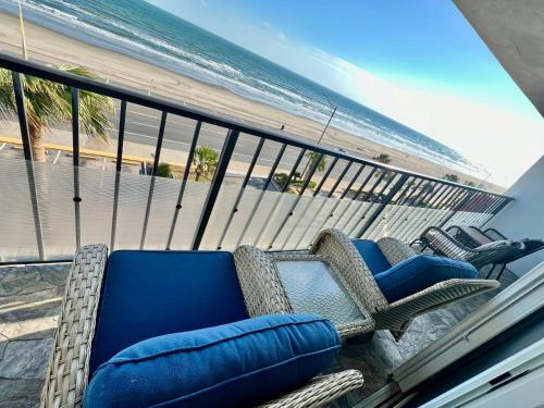 a balcony with a couch and chairs on the beach at Amazing and Spectacular ocean and beach views in Galveston in Galveston