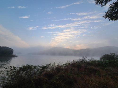 a view of a lake with fog on the water at Cheongna Stay in Sŏch'on