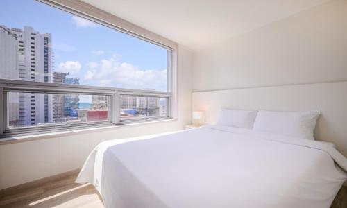 Postel nebo postele na pokoji v ubytování POL-A Resort Haeundae