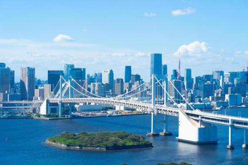 a bridge over the water in front of a city at HOSTEL LUND I -Oimachi- in Tokyo