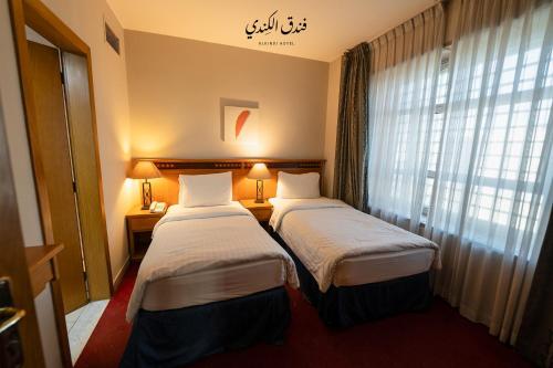 Katil atau katil-katil dalam bilik di Kindi Suite Hotel