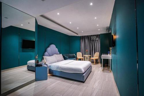 a bedroom with a king sized bed and a table at Sunny Day Hotel in Hong Kong