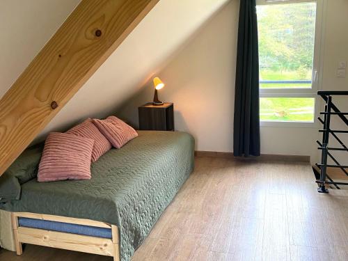 a bedroom with a bed with a wooden floor at Gîte paisible en Sologne avec jardin et parking privé - FR-1-590-525 in Ligny-le-Ribault