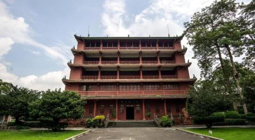 a large red building with stairs in a park at Lavande Hotel Guangzhou Quzhuang Metro Station in Guangzhou
