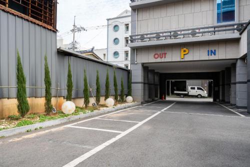 a parking lot with a tunnel with a truck in it at Yeosu Stay Hotel in Yeosu