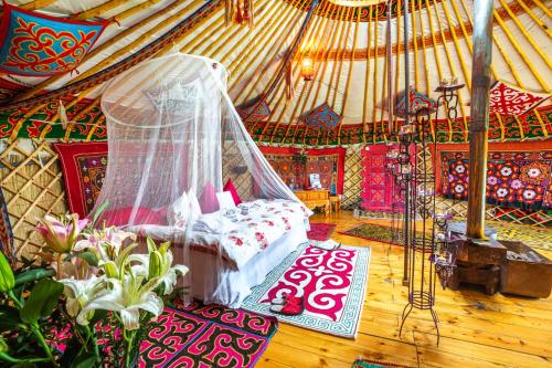 a room with a tent with a bed in it at Tuul Riverside Lodge in Gatsuurt